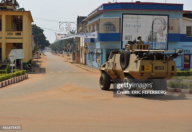 Chadian soldiers of the Misca stand at an empty crossroad on January 10, 2014 in Bangui after the announcement of the resignation of Central African...