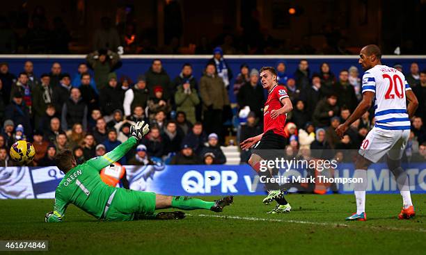 James Wilson of Manchester United scores his team's second goal past Robert Green of QPR during the Barclays Premier League match between Queens Park...