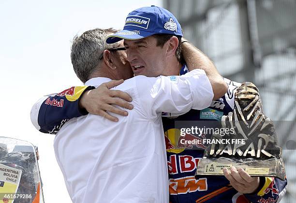 S Spanish biker Marc Coma receives his trophy from Dakar director Etienne Lavigne on the podium in Buenos Aires, Argentina, on January 17, 2015. Coma...