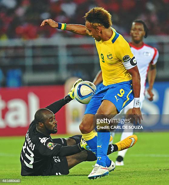 Gabon's forward Pierre-Emerick Aubameyang vies with Burkina's goalkeeper Germain Sanou on his way to score a goal during the 2015 African Cup of...