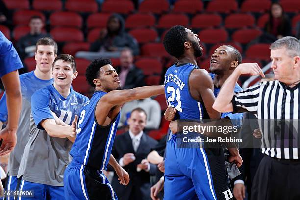 Amile Jefferson of the Duke Blue Devils celebrates with teammates Quinn Cook and Rasheed Sulaimon after making a basket against the Louisville during...