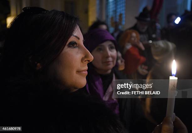 Tunisian women take part in a candlelight vigil in Tunis on January 17 in tribute to Tunisian national Yoav Hattab, one of the four Jewish men killed...