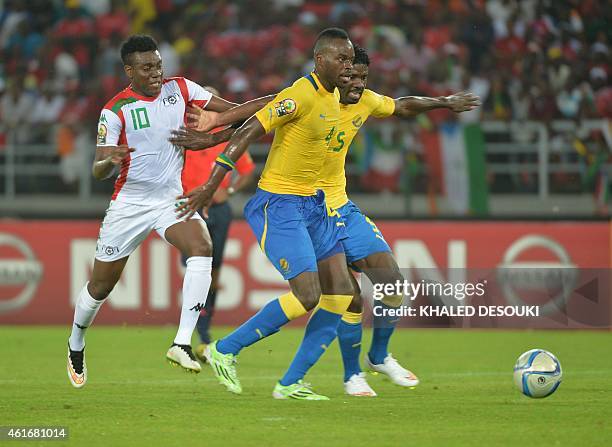 Burkina Faso's Alain Traore vies with Gabon's Yrondu Musavu-King and Bruno Ecuele Manga during the 2015 African Cup of Nations group A football match...