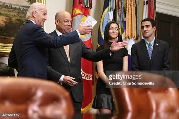 Vice President Joe Biden jokes with Homeland Security Secretary Jeh Johnson before ceremonally swearing him in with his children Natalie Johnson and...