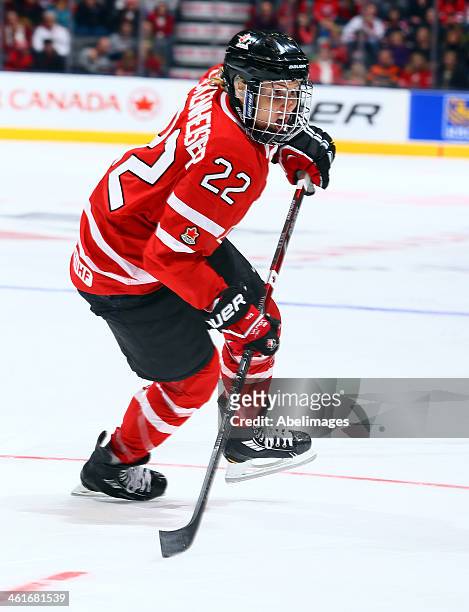 Hayley Wickenheiser of Team Canada skates up the ice against Team USA during a Sochi preparation game at the Air Canada Centre December 30, 2013 in...