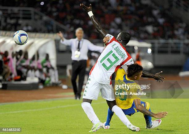 Burkina Faso's Narcisse Bambara vies for ball with Gabon's Frederic Bulot during Group A soccer match between Burkina Faso and Gabon at Bata Stadium...