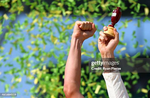 Michael Clarke of Australia lifts the urn during day three of the Fifth Ashes Test match between Australia and England at Sydney Cricket Ground on...