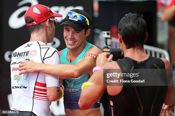 Tim Reed of Australia wins and congratulates Cameron Brown of New Zealand in third and Leon Griffin of Australia in second place at Ironman 70.0 on...