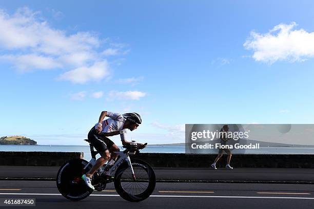 Competitors cycle along Tamaki Drive during Ironman 70.0 on January 18, 2015 in Auckland, New Zealand.