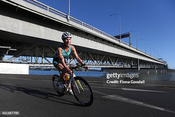 Elite Women's winner Meredith Kessler of USA cycles under the Auckland Harbour Bridge during Ironman 70.0 on January 18, 2015 in Auckland, New...