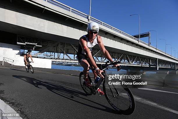 Josh Rix of Australia cycles under the Auckland Harbour Bridge during Ironman 70.0 on January 18, 2015 in Auckland, New Zealand.