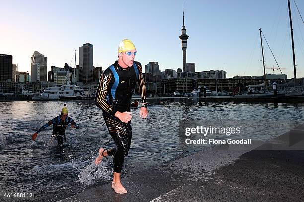 Compeitors leave the water after the swim leg in Ironman 70.0 on January 18, 2015 in Auckland, New Zealand.