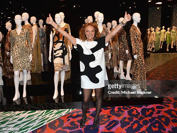 Designer Diane von Furstenberg poses for photographers in front of her collection of Wrap Dresses during the Journey of A Dress Exhibition at LACMA...