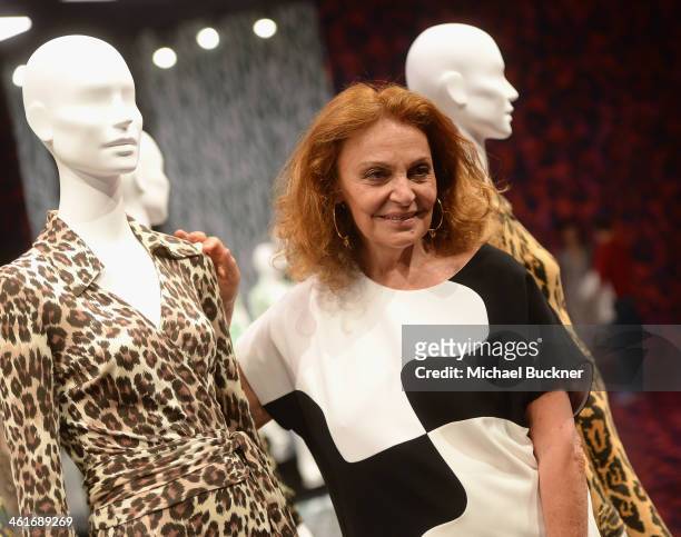Designer Diane von Furstenberg poses for photographers in front of her collection of Wrap Dresses during the press conference for the Journey of A...