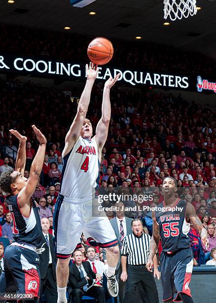 Guard T.J. McConnell of the Arizona Wildcats shoots over guard Brandon Taylor of the Utah Utes at McKale Center on January 17, 2015 in Tucson,...