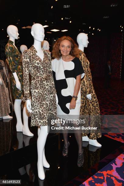 Designer Diane von Furstenberg poses for photographers in front of her collection of Wrap Dresses during the Journey of A Dress Exhibition at LACMA...