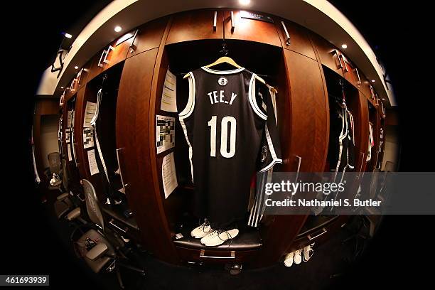 Tyshawn Taylor of the Brooklyn Nets jersey hangs in his locker prior to a game at the Barclays Center on January 10, 2014 in the Brooklyn borough of...