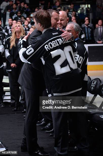 Rob Blake and Los Angeles Kings President of Business Operations Luc Robitaille hug during a jersey retirement ceremony before a game between the Los...