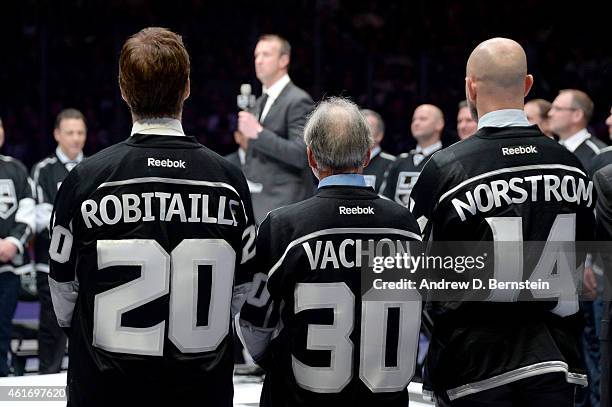 Los Angeles Kings President of Business Operations Luc Robitaille, Rogie Vachon, and Matias Norstrom watch as Rob Blake speaks during his jersey...