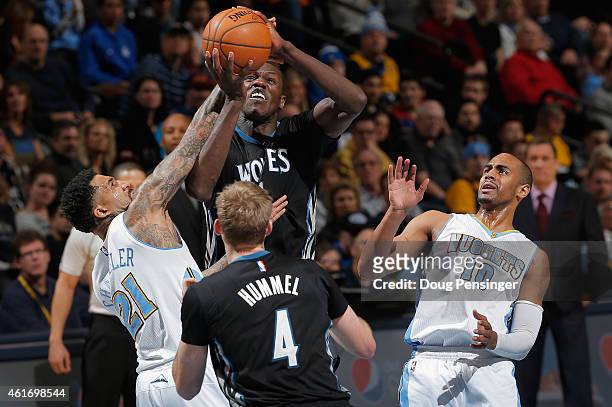 Gorgui Dieng of the Minnesota Timberwolves goes up for a shot and is fouled by Wilson Chandler of the Denver Nuggets at Pepsi Center on January 17,...