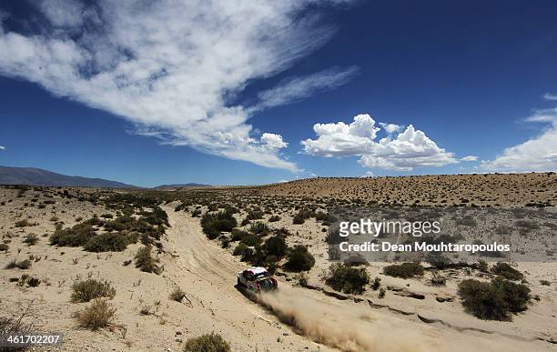 Giniel De Villiers of South Africa and Dirk Von Zitzewitz of Germany for Imperial Toyota compete in the Dakar Rally during Day 5 of the 2014 Dakar...