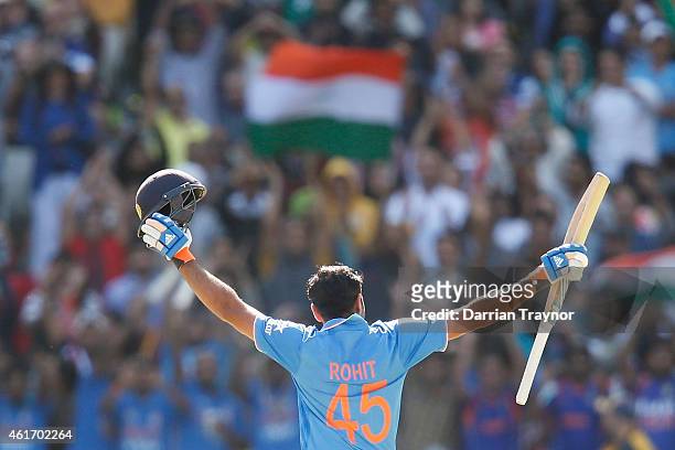 Rohit Sharma of India raises his bat after scoring 100 runs during the One Day International match between Australia and India at Melbourne Cricket...