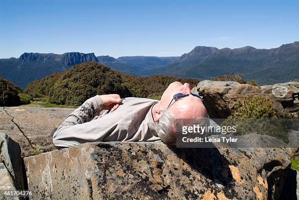 Guest from the Cradle Mountain Huts relaxes in the sun while on the Overland Track. Cradle Mountain Lodges is an eco-tourism company that specializes...