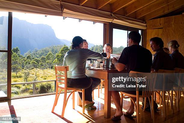 Cradle Mountain Huts guests having breakfast while on the Overland Track. Cradle Mountain Lodges is an eco-tourism company specializing in guided...