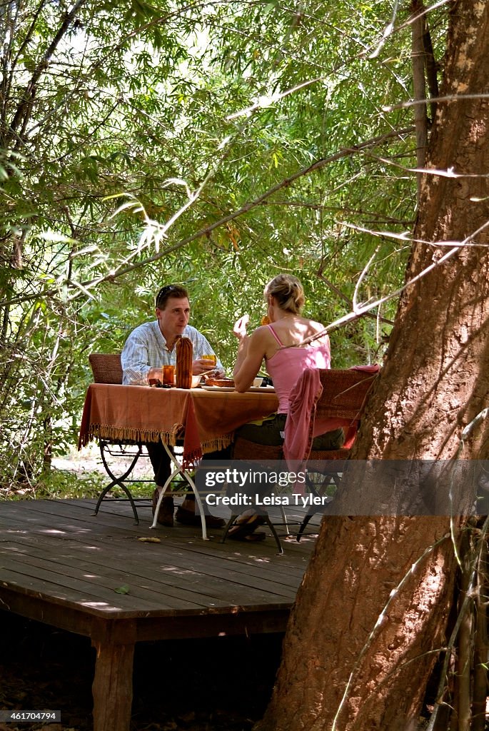 Guests enjoying lunch at Mahua Kothi, a safari lodge on the...