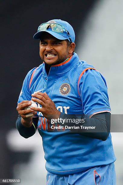 Suresh Raina of India reacts after taking a catch to dismiss David Warner of Australia during the One Day International match between Australia and...