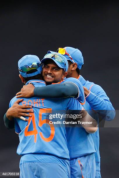 Suresh Raina of India embraces Rohit Sharma after taking a catch to dismiss David Warner of Australia during the One Day International match between...