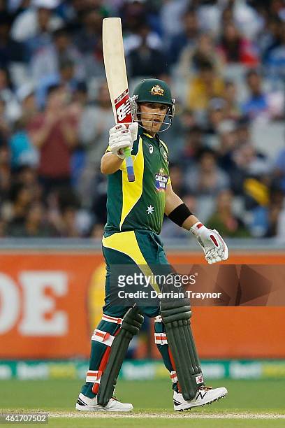 Aaron Finch of Australia raises his bat after scoring 50 runs during the One Day International match between Australia and India at Melbourne Cricket...