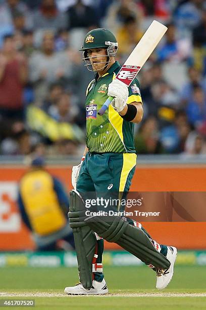 Aaron Finch of Australia raises his bat after scoring 50 runs during the One Day International match between Australia and India at Melbourne Cricket...
