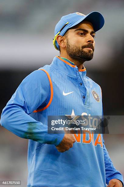 Virat Kohli of India points to the India logo on his clothing as he gestures to fans during the One Day International match between Australia and...