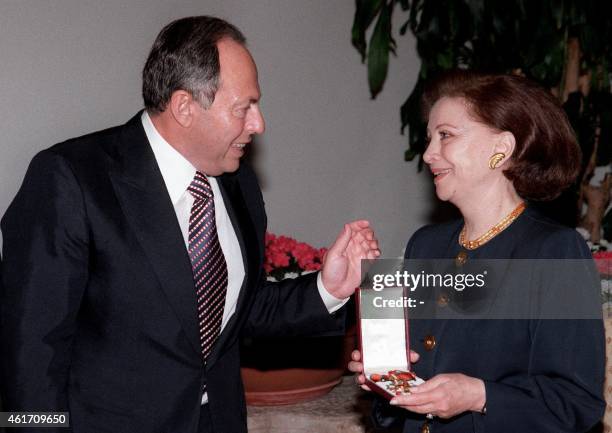 Lebanese President Emile Lahoud speaks with Egyptian actress Faten Hamama after giving her a National Order of the Cedar medal in honour of her...