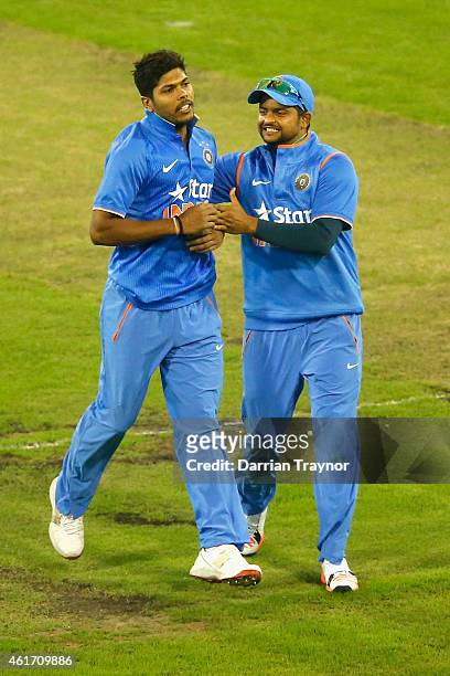 Umesh Yadav and Suresh Raina of India celebrate the wicket of Aaron Finch of Australia during the One Day International match between Australia and...