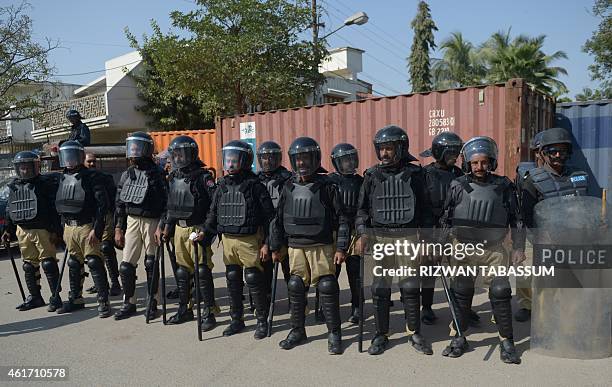 Pakistani policemen stand guard outside the French consulate following protests there against the printing of satirical sketches of the Prophet...