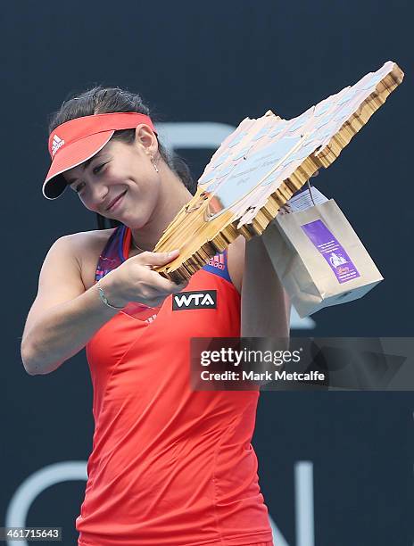 Garbine Muguruza of Spain poses with the winners trophy after victory in her singles final match against Klara Zakopalova of the Czech Republic...