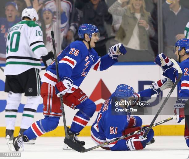 Rick Nash of the New York Rangers celebrates his game winning goal with teammates Chris Kreider and Derek Stepan in the third period against the...