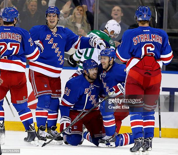 Rick Nash of the New York Rangers celebrates his game winning goal with teammates Chris Kreider and Derek Stepan in the third period against the...