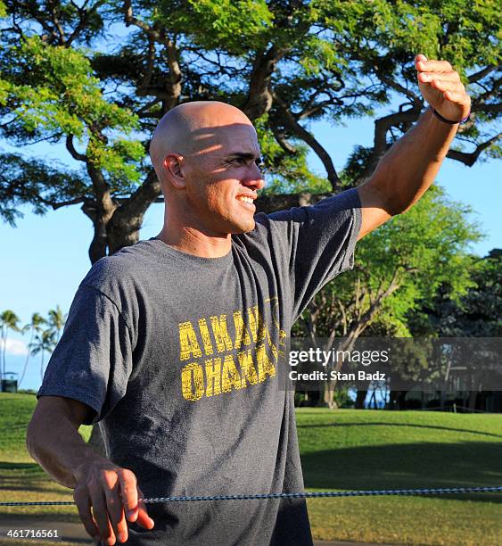 Champion surfer Kelly Slater watches his friend Adam Scott of Australia play a shot on the 18th hole during the second round of the Sony Open in...