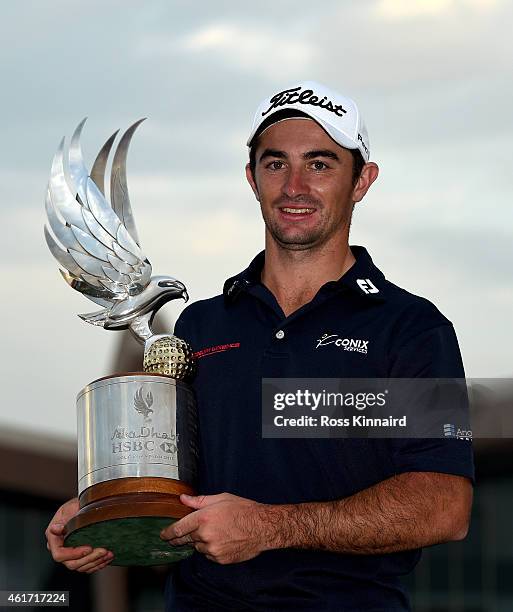Gary Stal of France celebrates with the winners trophy after the final round of the Abu Dhabi HSBC Golf Championship at the Abu Dhabi Golf Club on...