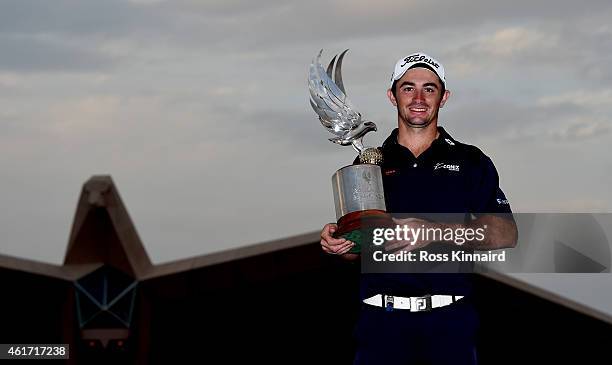 Gary Stal of France celebrates with the winners trophy after the final round of the Abu Dhabi HSBC Golf Championship at the Abu Dhabi Golf Club on...