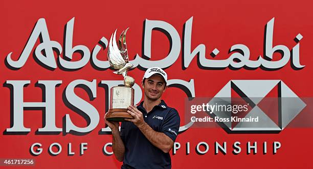 Gary Stal of France celebrates with the winners trophy after the final round of the Abu Dhabi HSBC Golf Championship at the Abu Dhabi Golf Club on...