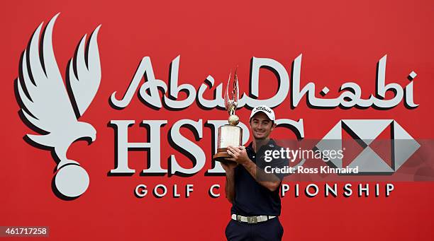 Gary Stal of France celebrates with the winners trophy after the final round of the Abu Dhabi HSBC Golf Championship at the Abu Dhabi Golf Club on...