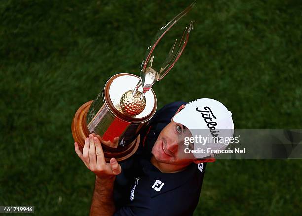 Gary Stal of France celebrates with the winners trophy after the final round of the Abu Dhabi HSBC Golf Championship at Abu Dhabi Golf Club on...
