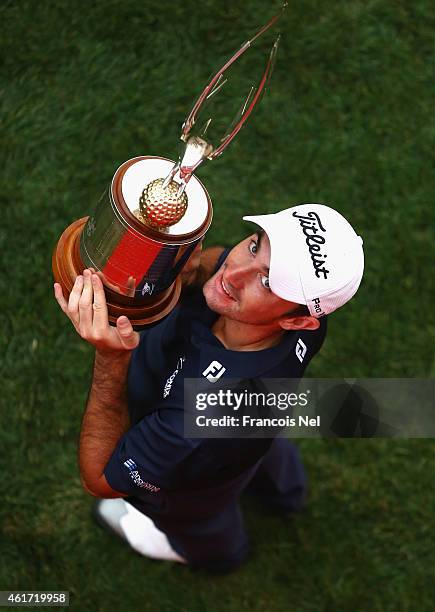 Gary Stal of France celebrates with the winners trophy after the final round of the Abu Dhabi HSBC Golf Championship at Abu Dhabi Golf Club on...