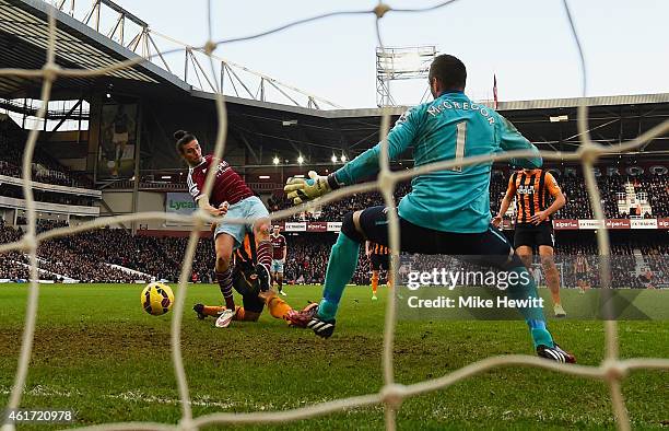 Andy Carroll of West Ham United shoots past goalkeeper Allan McGregor of Hull City to score their first goal during the Barclays Premier League match...