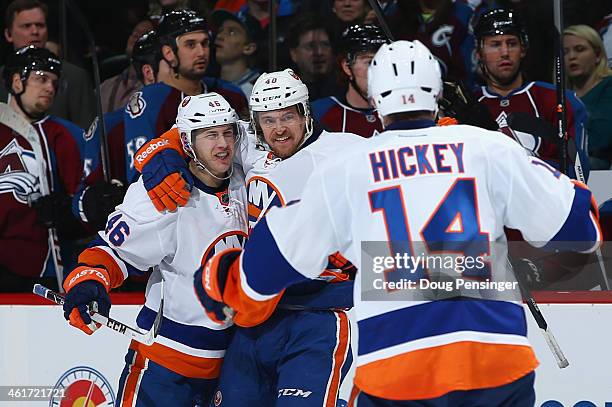 Michael Grabner of the New York Islanders celebrates his game winning overtime goal against the Colorado Avalanche with Matt Donovan and Thomas...