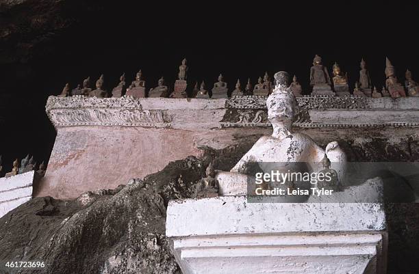 Buddhist statues in the Pak Ou Caves - two limestone caves jutting into a cliff face on the Mekong River, to the north of Luang Prabang. Made...